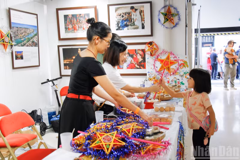 A girl beams with delight as she receives a star-shaped lantern from the organisers at the festival.