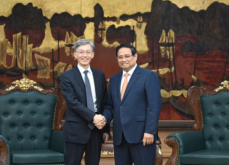Prime Minister Pham Minh Chinh (R) welcomes Deputy Managing Director of the International Monetary Fund Kenji Okamura. (Photo: NDO)
