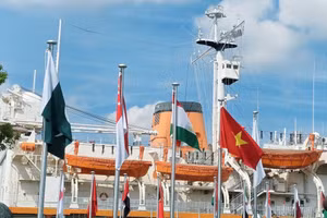 The national flag of Viet Nam flies alongside the flags of other countries at the 2026 Asian Games. (Photo: Viet Nam Sports Delegation)