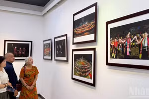 Visitors admire the photographic works on display.