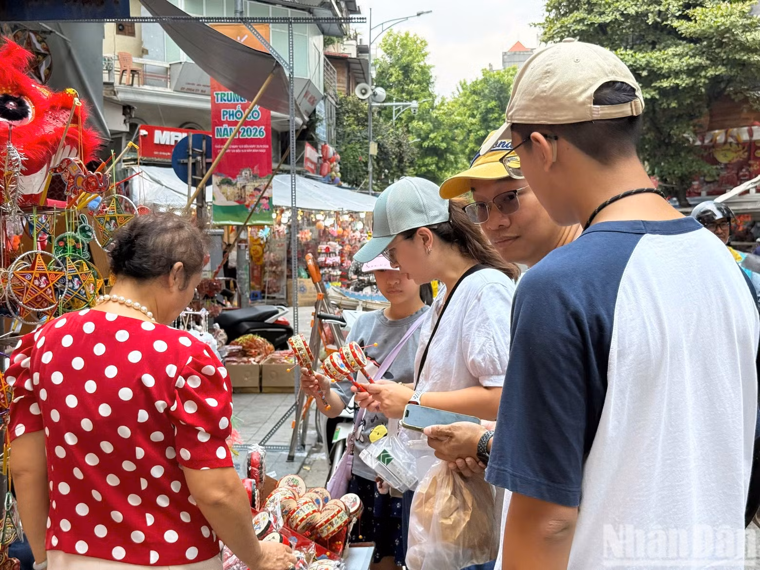 Tourists show interest in folk toys such as traditional drums.