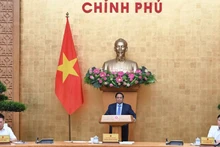 Prime Minister Pham Minh Chinh chairs the Government meeting in Ha Noi on October 1 to review the implementation and address challenges related to the two-tier local administration model. (Photo: Tran Hai)