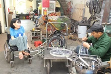 Nga discusses tricycle designs for the disabled with her companion.