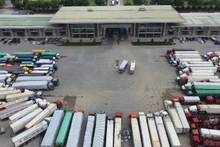 Container trucks wait for customs clearance at Kim Thanh International Border Gate.