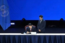 Minister of Public Security Luong Tam Quang signs the United Nations Convention against Cybercrime. (Photo: Thuy Nguyen)