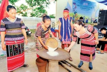 Members of the Xtieng ethnic group in Tan Hung Commune pound rice during the new rice festival.