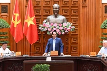 Prime Minister Pham Minh Chinh speaks at the meeting of the Government’s standing members on addressing the aftermath of natural disasters. (Photo: Tran Hai)