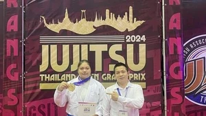 Jujitsu fighter Nguyen Thị Thanh Truc (left) and her coach pose for a photo after winning gold at the 2024 Thailand Open Grand Prix. (Photo of Thanh Truc)