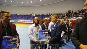 President of the World Vovinam Federation (WVVF) Mai Huu Tin is with outstanding sponsors and coaches at Vovinam Day in Algeria, taking place on May 9. (Photo: published by VNA)