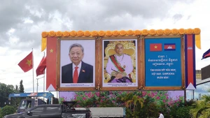 Portraits of Vietnamese Party General Secretary To Lam (L) and King Preah Bat Samdech Preah Boromneath Norodom Sihamoni on a street in Phnom Penh. (Photo by NGUYEN HIEP)