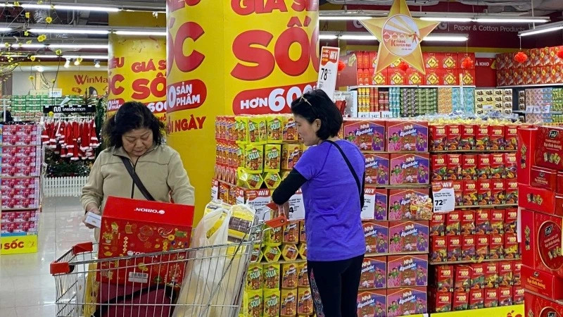 Consumers shop at Winmart Royal City supermarket in Hanoi.