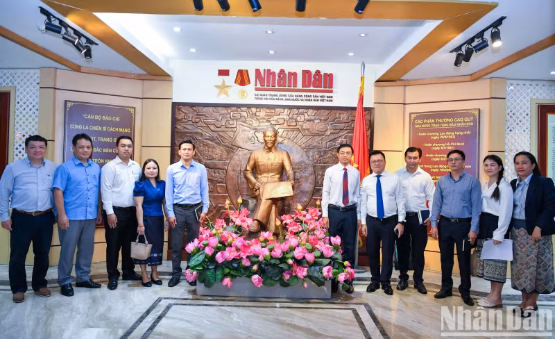 Leaders of Nhan Dan Newspaper and a Pasaxon Newspaper delegation pose for a souvenir photo at Nhan Dan Newspaper Traditional House. (Photo: NDO)