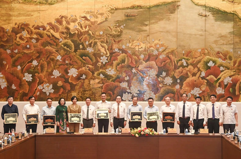 National Assembly Chairman Tran Thanh Man (8th, R) and representatives of press agencies at the meeting in Hanoi on June 19. (Photo: NDO)