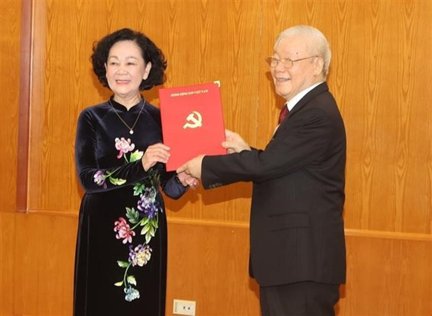 Party General Secretary Nguyen Phu Trong (right) presents the Political Bureau's decision to Truong Thi Mai. (Photo: VNA)