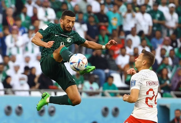 Saudi Arabia’s Abdulellah Al-Malki in action with Poland's Przemyslaw Frankowski. (Photo: Reuters)