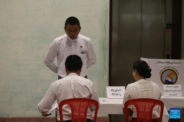 A voter checks in at a polling station in Yangon, Myanmar, Dec. 28, 2025. Myanmar kicked off its 2025 multi-party democratic general election with the first phase held on Sunday. The general election is scheduled to be held in three phases, with the second phase set for Jan. 11, 2026, followed by the third phase on Jan. 25. (Photo: Xinhua)