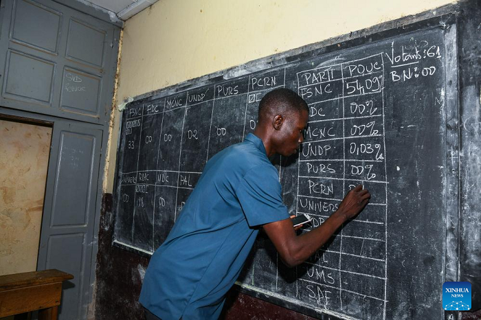 An election official records ballot counts on a blackboard at a polling station in Yaounde, capital of Cameroon, on Oct. 12, 2025. Voting for Cameroon's presidential election ended on Sunday evening, with ballot counting now underway across the country. Polling opened at 8:00 a.m. and closed at 6:00 p.m. local time, with more than eight million registered voters casting their ballots to choose the country's next president. According to Cameroon's Electoral Code, the Constitutional Council must announce the official results within 15 days. (Photo: Xinhua)