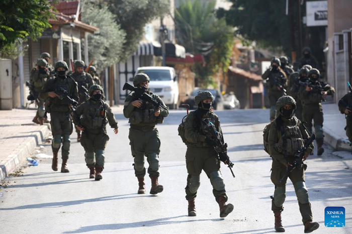 Israeli soldiers are seen during a military operation in the West Bank city of Qalqilya, Dec. 4, 2025. Israeli forces expanded their military campaign in the northern West Bank on Thursday, imposing a tight cordon on the Kafr Saba neighborhood in Qalqilya and restricting Palestinian movement in the area. (Photo: Xinhua)