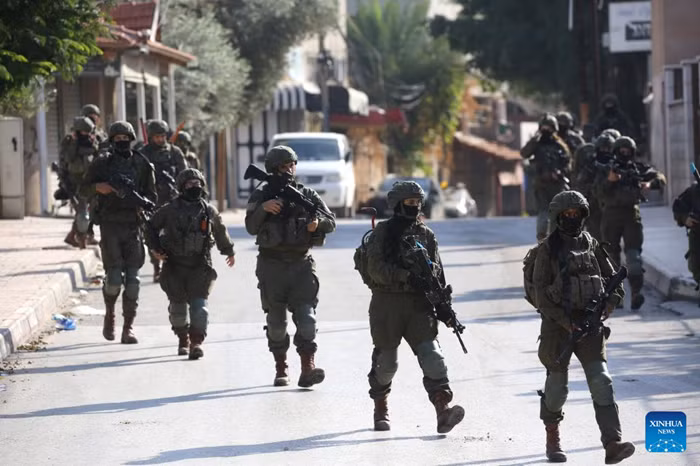 Israeli soldiers are seen during a military operation in the West Bank city of Qalqilya, Dec. 4, 2025. Israeli forces expanded their military campaign in the northern West Bank on Thursday, imposing a tight cordon on the Kafr Saba neighborhood in Qalqilya and restricting Palestinian movement in the area. (Photo: Xinhua)