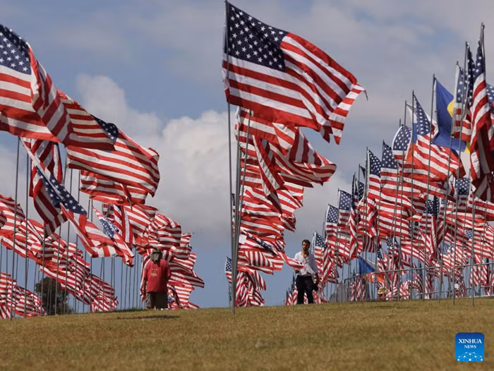 People walk among the Waves of Flags at Pepperdine University in Malibu, California, the United States, on Sept. 10, 2025. Each September, the university stages the Waves of Flags display to honor the victims of the 9/11 attacks. (Photo: Xinhua) 