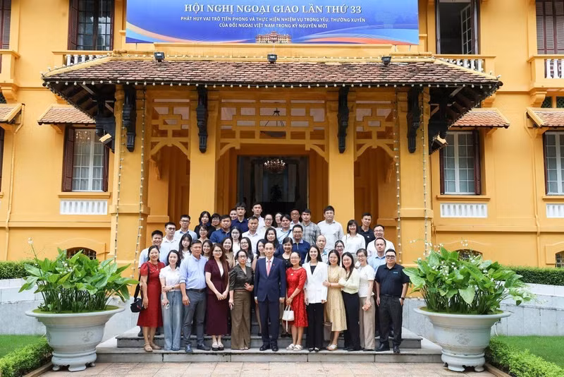 Minister of Foreign Affairs Le Hoai Trung and reporters pose for a group photo (Photo courtesy of the Ministry of Foreign Affairs)