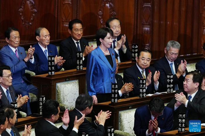 Takaichi Sanae (C) rises to accept a round of applause after winning the prime ministerial designation vote in the House of Representatives in Tokyo, Japan, Oct. 21, 2025. Takaichi Sanae, leader of Japan's ruling Liberal Democratic Party (LDP), was officially elected the country's prime minister on Tuesday after winning in both houses of parliament, becoming the country's first female leader. (Photo: Xinhua)