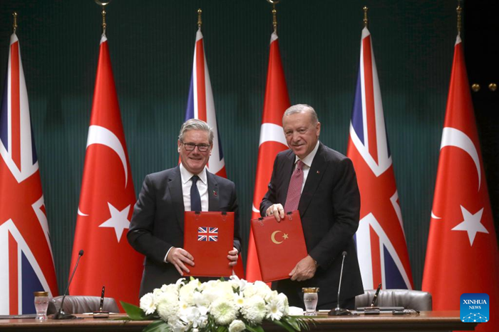 Turkish President Recep Tayyip Erdogan (R) and British Prime Minister Keir Starmer display the signed agreement in Ankara, Türkiye, Oct. 27, 2025. Türkiye signed a deal on Monday to buy 20 Eurofighter Typhoon fighter jets from Britain for 8 billion pounds (10.64 billion USD), as Ankara seeks to bolster its defense capabilities amid a turbulent regional landscape. (Mustafa Kaya/Handout via Xinhua)