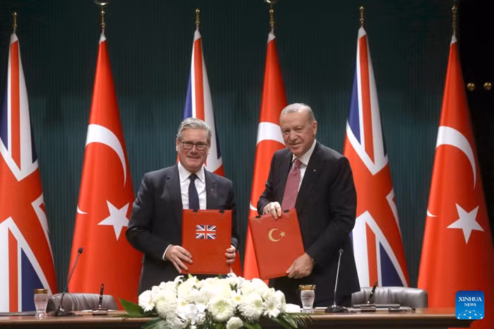 Turkish President Recep Tayyip Erdogan (R) and British Prime Minister Keir Starmer display the signed agreement in Ankara, Türkiye, Oct. 27, 2025. Türkiye signed a deal on Monday to buy 20 Eurofighter Typhoon fighter jets from Britain for 8 billion pounds (10.64 billion USD), as Ankara seeks to bolster its defense capabilities amid a turbulent regional landscape. (Mustafa Kaya/Handout via Xinhua)