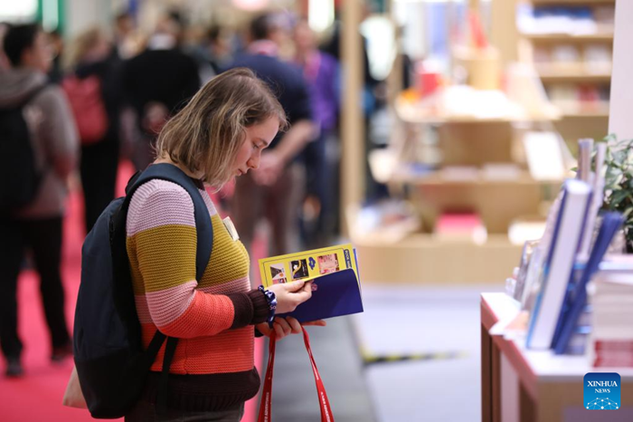 A woman visits the Frankfurt Book Fair in Frankfurt, Germany, Oct. 16, 2025. The world's largest book fair, the Frankfurt Book Fair, opened here on Tuesday with a focus on licensing and rights exchange. More than 4,000 publishers from over 90 countries and regions are present at the 77th book fair and more than 200,000 visitors are expected, said Juergen Boos, director of the Fair, at the opening ceremony. (Photo: Xinhua)