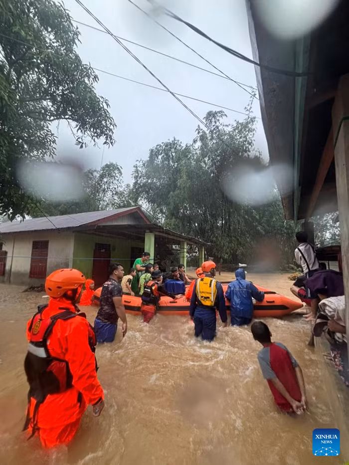 This photo taken on Nov. 25, 2025 and released by Indonesia's National Search And Rescue Agency (Basarnas) shows rescue team evacuating stranded villagers with a rubber boat as heavy rain hits North Sumatra, Indonesia. 13 people have died after floods and landslides struck seven regencies and cities in Indonesia's North Sumatra province, the Provincial Disaster Management Agency (BPBD) said Wednesday.