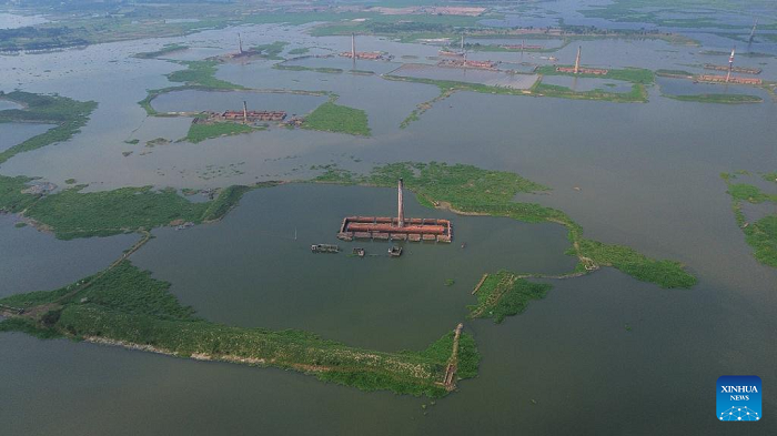 An aerial drone photo taken on Oct. 25, 2025 shows some brickyards half submerged in floodwater in Dhaka, Bangladesh. Heavy rainfall and rising river levels have submerged low-lying areas around the capital including some brickyards. (Photo: Xinhua)