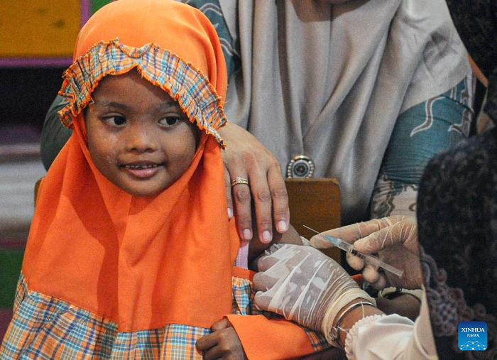 A girl smiles before receiving a dose of measles vaccine in Sumenep Regency, East Java, Indonesia, on Aug. 27, 2025. Indonesia has recorded 46 measles cases across 42 districts and cities in 13 provinces, with Sumenep in East Java identified as the worst-affected area with 17 deaths, the Ministry of Health said on Tuesday. (Photo: Xinhua)