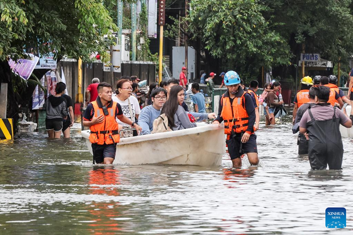 Rescuers use a boat to evacuate residents from a flooded area in Navotas City, the Philippines, Nov. 10, 2025. Super Typhoon Fung-wong made landfall over Aurora province in the eastern part of Luzon Island of the Philippines on Sunday night, according to the state weather bureau. Fung-wong is the 21st tropical cyclone hitting the Philippines this year, surpassing the country's annual average of 20 storms. (Photo: Xinhua)