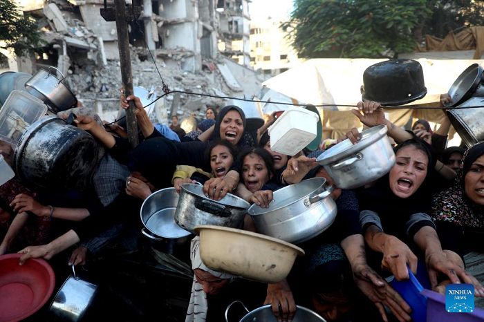 Palestinians wait to receive food in the Al-Rimal neighborhood of central Gaza City, on July 20, 2025. The total death toll of hunger in Gaza since March has reached 86, including 76 children, the Gaza-based health authorities said Sunday. (Photo: Xinhua)