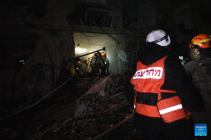 Emergency responders work at an impact site of an Iranian missile attack in Dimona, southern Israel, March 21, 2026. A missile fired from Iran injured 47 people in the southern Israeli city of Dimona on Saturday night, including a 10-year-old boy in serious condition, according to Israel's national emergency service Magen David Adom (MDA). (Israel Defense Forces/Handout via Xinhua)