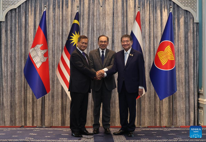 Malaysian Prime Minister Anwar Ibrahim (C), Cambodian Prime Minister Hun Manet (L) and Thailand's acting Prime Minister Phumtham Wechayachai shake hands in Putrajaya, Malaysia, July 28, 2025. Thailand and Cambodia's leaders have agreed to implement a ceasefire starting midnight on Monday, Malaysian Prime Minister Anwar Ibrahim said following a meeting hosted by him here. (Bernama via Xinhua)