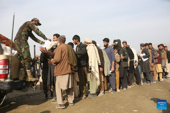 Afghan returnees receive food at a temporary camp at the Torkham border crossing, Afghanistan, Dec. 16, 2025. As the world marks International Migrants Day on Thursday, the unfolding narrative in Afghanistan is one of resilience and uncertainty. The forced return of thousands from neighboring countries is reshaping lives: many families are coming back to a homeland they barely know, striving to rebuild amid fragile security and limited support. (Photo: Xinhua)