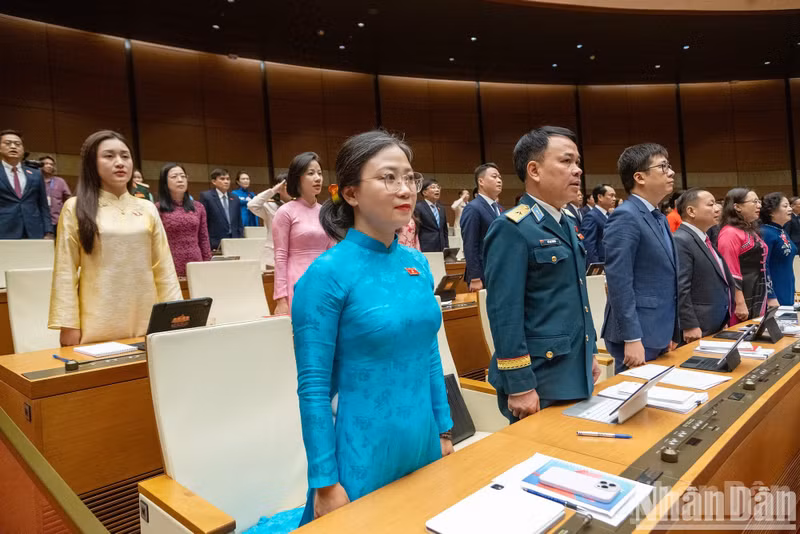 National Assembly deputies participate in the flag-raising ceremony at the opening session.