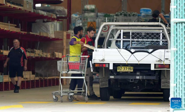 A staff member loads a wooden board at the Bunnings store in Tuggeranong, Canberra, Australia, on March 20, 2026. Australia's unemployment rate rose to 4.3 percent in February, according to official data, defying economists' expectations that it would remain steady. (Photo: Xinhua)