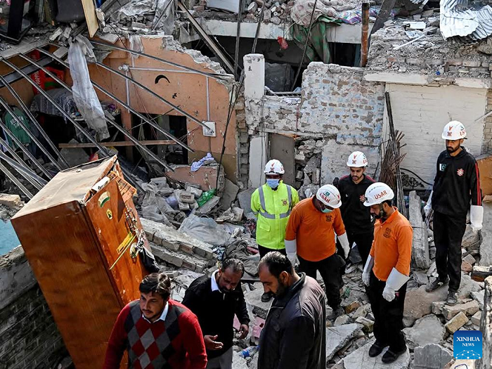Security personnel examine the site of a gas explosion in Islamabad, capital of Pakistan, on Jan. 11, 2026. The death toll from a gas explosion at a wedding house in Pakistan's federal capital, Islamabad, has risen to eight, including a newlywed couple, while 11 others were injured, local authorities said on Sunday. Authorities said the exact cause of the explosion will be determined following a detailed investigation. (Str/Xinhua)