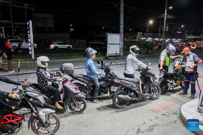Motorcyclists line up to refuel their vehicles at a gas station in Quezon City, the Philippines, on March 9, 2026. Motorists across the Philippines swarmed gasoline stations on Monday, rushing to refuel ahead of a massive price hike scheduled for Tuesday. Oil prices are expected to increase by about 17 pesos to 24 pesos (roughly 0.29 USD to 0.40 dollars) per liter this week, said Energy Secretary Sharon Garin on Monday. (Photo: Xinhua)
