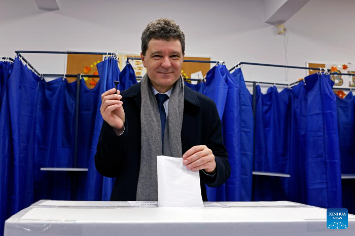 Romanian President Nicusor Dan votes during a local election at a polling station in Bucharest, Romania, on Dec. 7, 2025. Bucharest's citizens on Sunday vote in a local mayoral election after the former mayor Nicusor Dan was elected as Romanian president in May. (Photo: Xinhua)