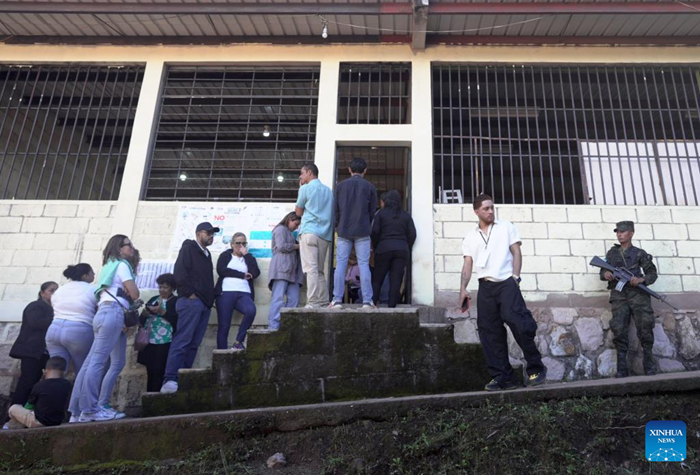Voters line up as they wait to cast their ballots at a polling station during the general elections in Tegucigalpa, capital of Honduras, Nov. 30, 2025. Honduras on Sunday launched nationwide general elections to choose a new president and members of Congress. (Photo: Xinhua)