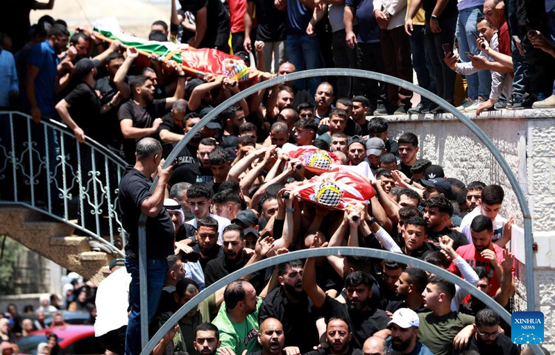 People carry the bodies of three Palestinians killed in an Israeli settler attack in the town of Kafr Malik east of Ramallah, central West Bank, on June 26, 2025. Three Palestinians were killed and seven others injured on Wednesday by live bullets during an Israeli settler attack on the town of Kafr Malik east of Ramallah, central West Bank, the Palestinian official news agency WAFA reported. (Photo: Xinhua)