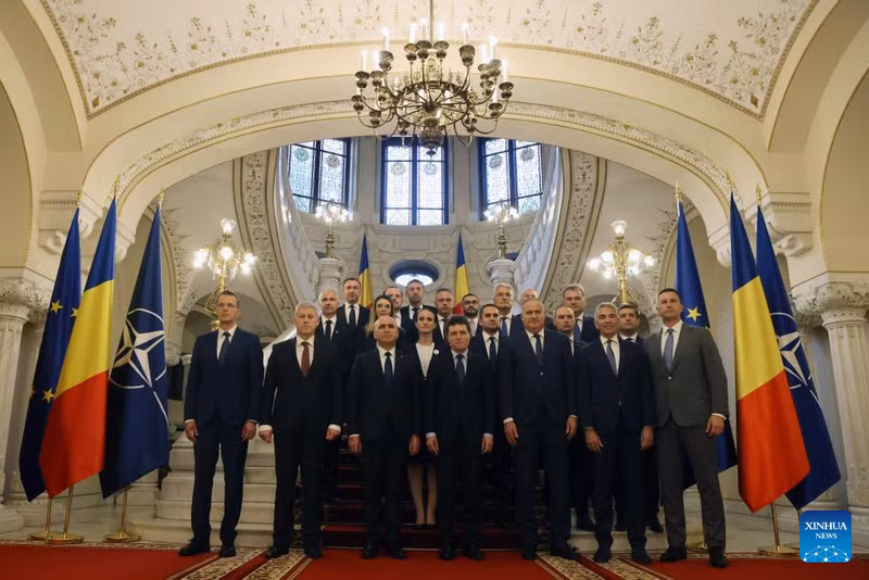 Romanian President Nicusor Dan (C, Front) poses with members of the new government headed by Prime Minister Ilie Bolojan (3rd L, Front) after a swearing-in ceremony at the Cotroceni presidential palace in Bucharest, Romania, on June 23, 2025. Romania's new pro-European government, led by Prime Minister Ilie Bolojan, was sworn in Monday evening before President Nicusor Dan, marking the end of a period of political instability and interim leadership. (Photo: Xinhua)