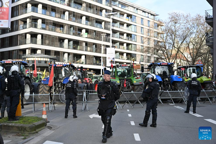 Police officers secure a road as farmers park tractors during a protest near the Europa Building in Brussels, Belgium, Dec. 18, 2025. Thousands of farmers from across Europe rallied near the European Parliament and the Europa Building in Brussels on Thursday as European Union (EU) leaders convened for a summit, with a long-negotiated trade deal with the South American bloc Mercosur on the agenda. (Photo: Xinhua)