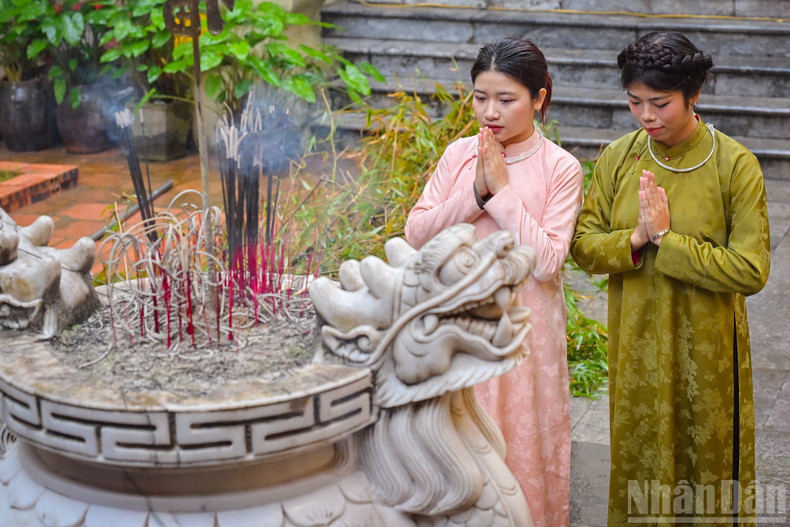 Young people offer incense, praying for a smooth and prosperous new year.