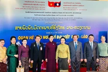 Madame Ngo Phuong Ly (fifth from left), Madame Naly Sisoulith (sixth from left), and officials of the two countries at the opening ceremony of the Viet Nam Film Week and the photo exhibition on December 2 (Photo: The thao & Van hoa newspaper) 