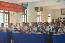 Officers, soldiers and residents on Truong Sa Island watch the live broadcast of the opening session of the 14th National Party Congress.