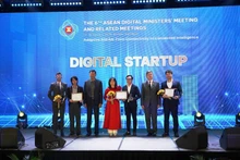 A representative of MedCAT (in red) receives the Gold Award in the startup category.